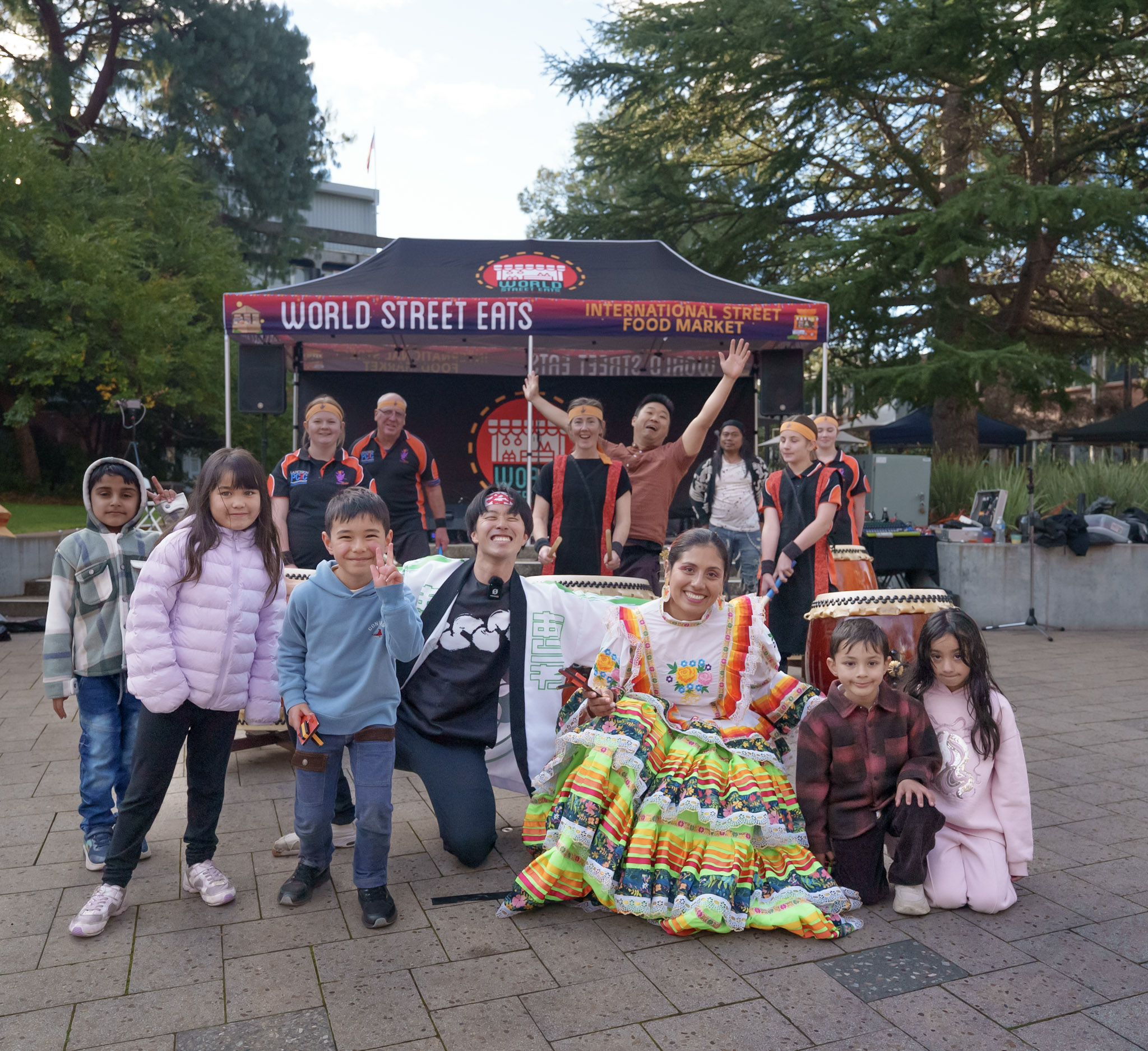 World Street Eats Launceston — multicultural group photo with World Street Eats banner
